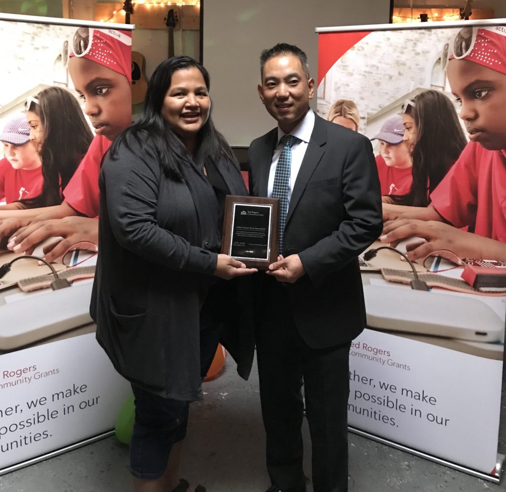 Urban Native Youth Association Executive Director Cheryl Robinson accepts the Rogers Community Grant from Mark Nariiwa, Rogers Communications.
